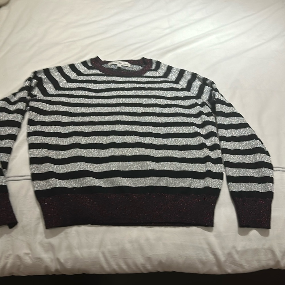 Gorgeous sweater with bright silver and shiny burgundy detailing.